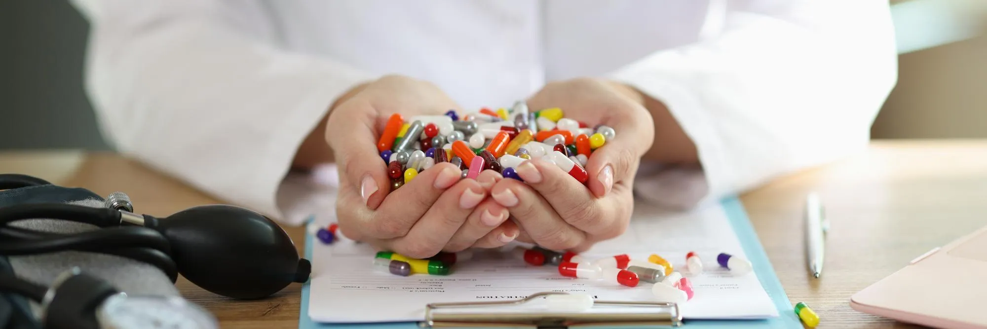Pharmacist reviewing medications and prescription information in a pharmacy.