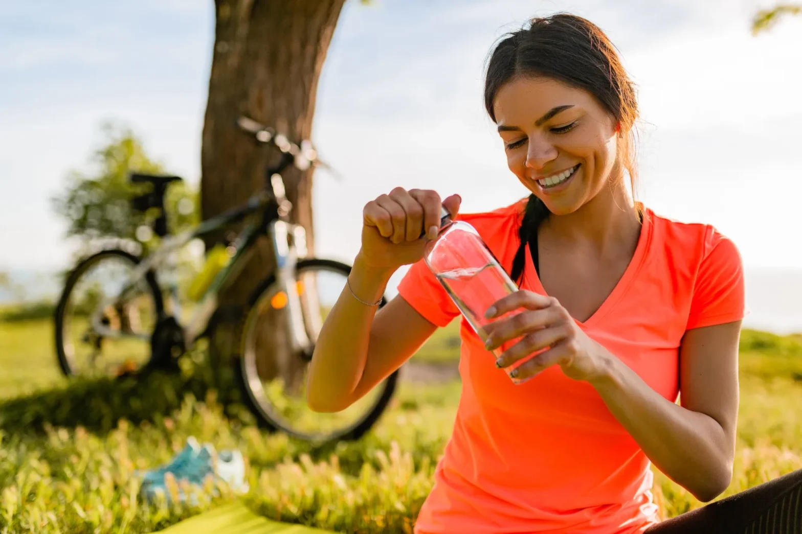 Woman drinking water after exercise to support a healthy immune system with wellness advice from a professional pharmacy Jacksonville.