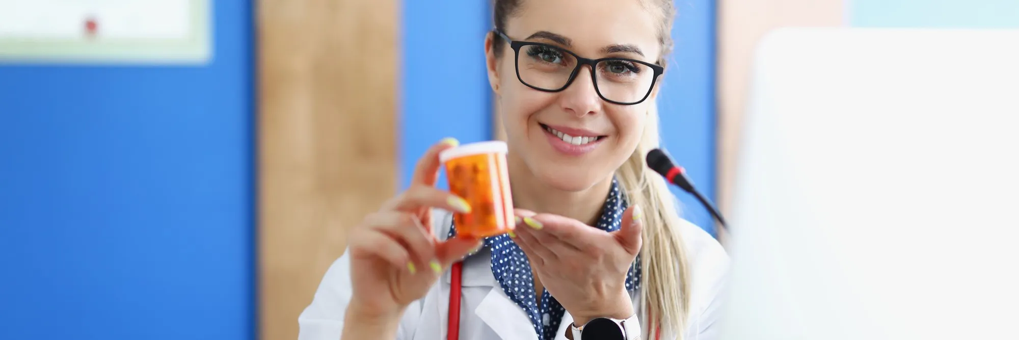Pharmacist holding a prescription medication bottle in a Pharmacy in Jacksonville, FL.
