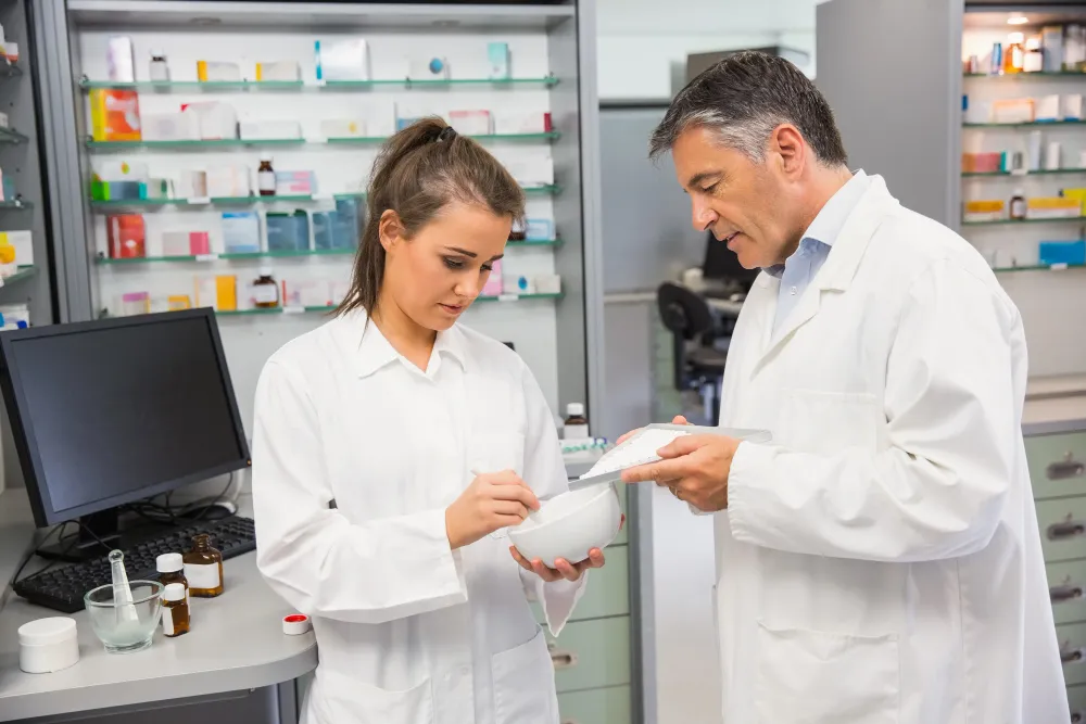 Pharmacists preparing medications and discussing prescription services in a pharmacy, representing Pharmacy Services Jacksonville.