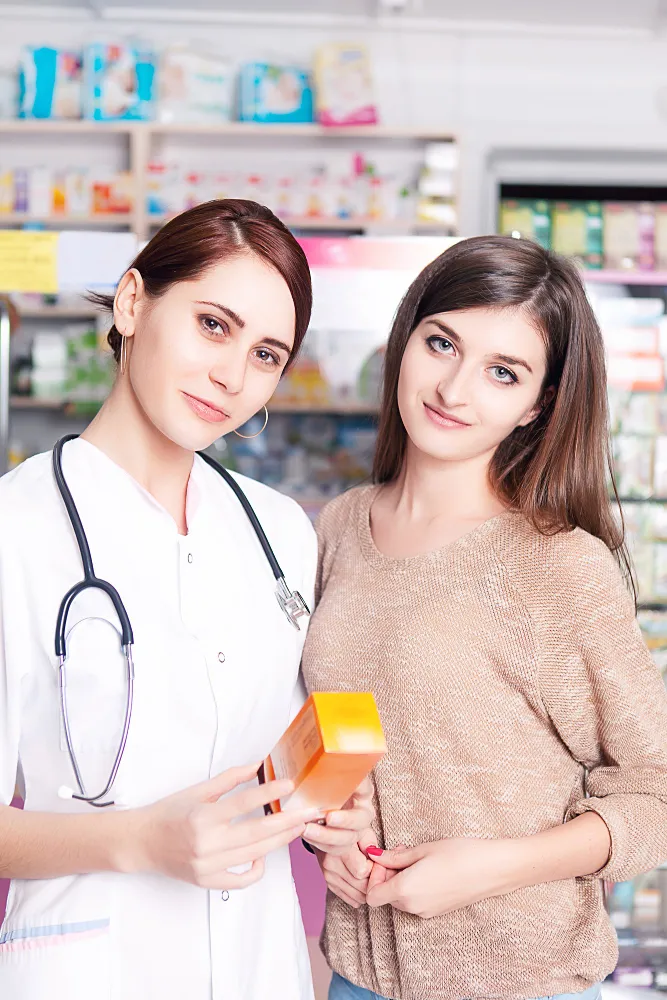 Pharmacist consulting with a patient inside a pharmacy, highlighting how Pharmacy Clinical Services impact patient education, medication guidance, and better health outcomes