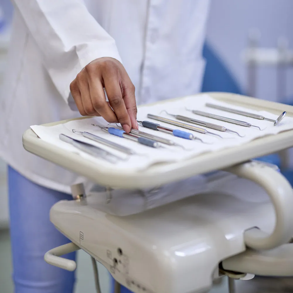 Healthcare professional selecting sterilized instruments from a tray, representing reliable medical equipment supply and essential tools used in clinical and medical supply pharmacy environments