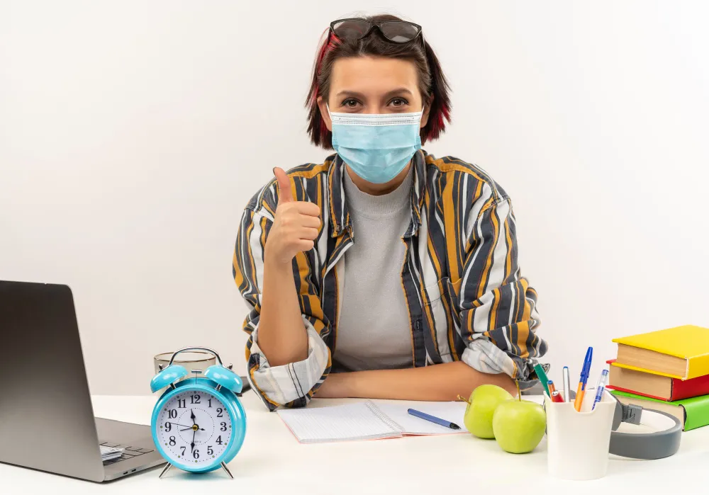 Woman working at a desk with a positive gesture, symbolizing convenience and ease when using a reliable drug store to refill prescriptions quickly and efficiently
