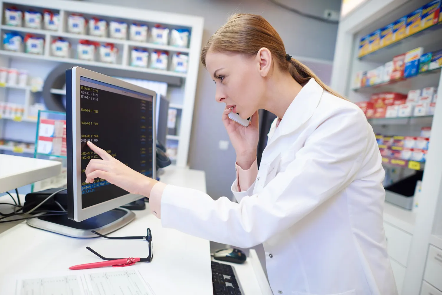 Clinical pharmacist using pharmacy software to deliver Clinical Intervention Services, verify prescriptions, and complete a Comprehensive Medication Assessment for safer, more effective medication management.