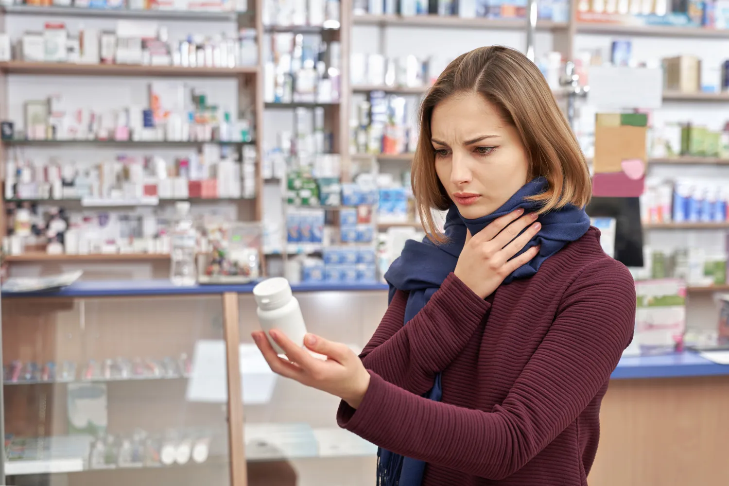 Patient reviewing a prescription medication bottle inside a specialty pharmacy while receiving guidance on high-complexity medication solutions and specialty pharmacy services.