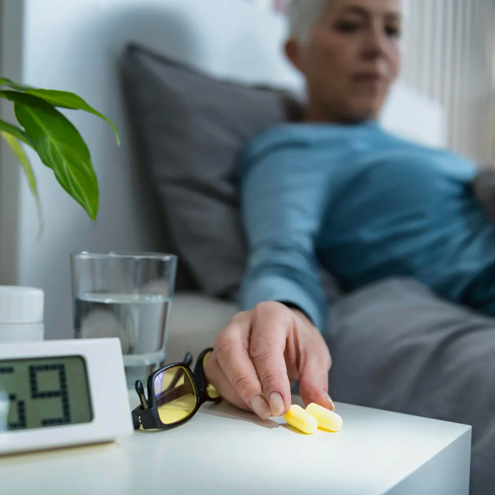 Patient resting at home with medication and medical essentials nearby, illustrating how durable medical equipment and home medical supplies promote a safe, comfortable recovery after illness or surgery in Jacksonville, FL.