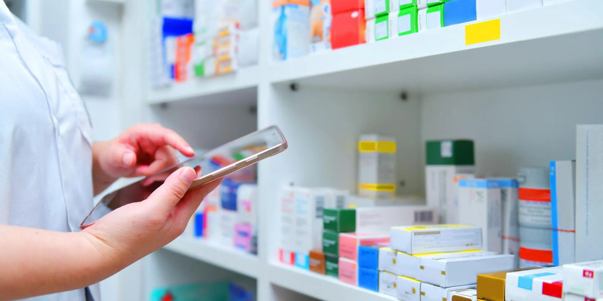 Pharmacist using a digital device for pharmacy medication synchronization and pharmacist medication management.