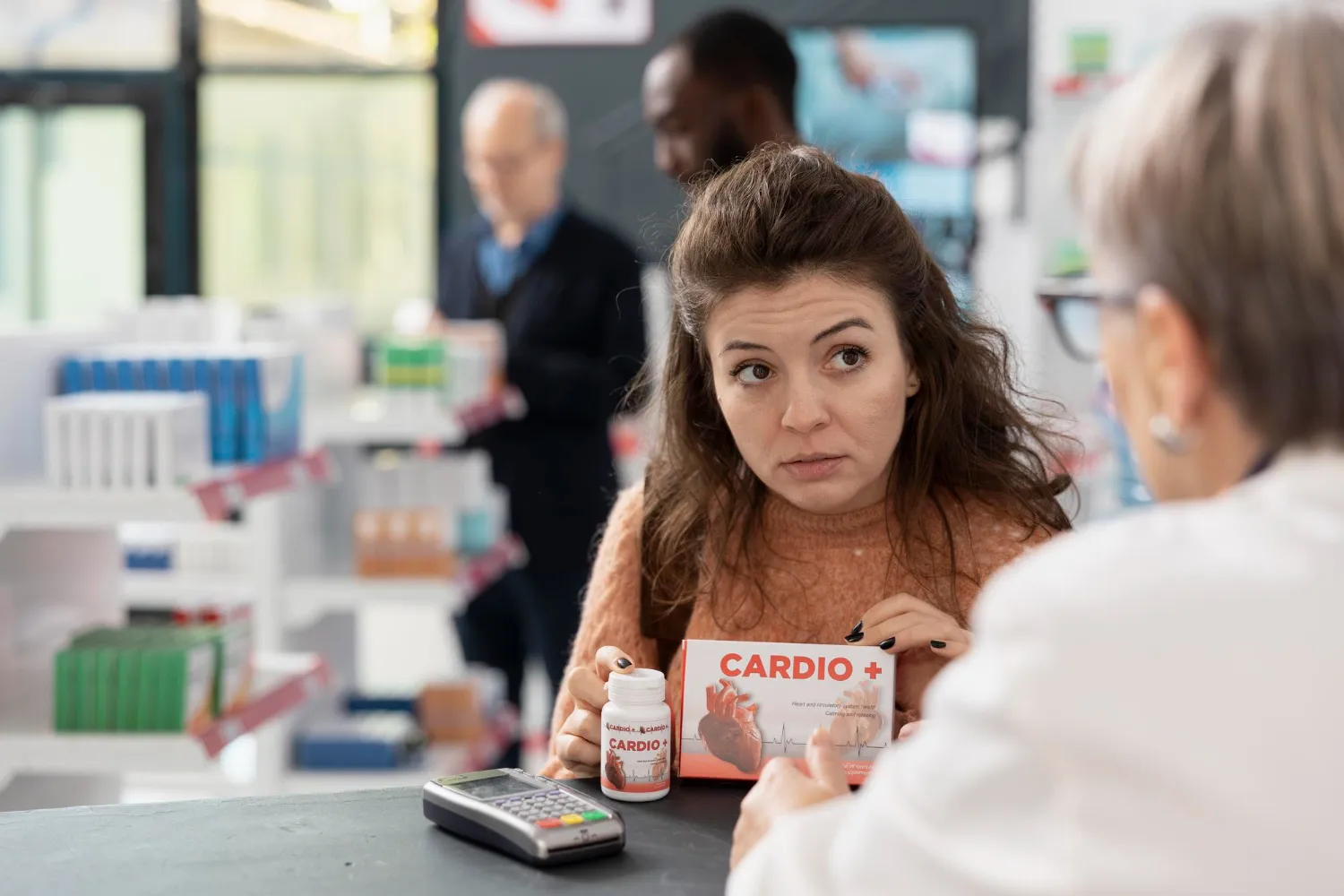 Patient discussing medication options with a pharmacist at a pharmacy counter, illustrating specialty pharmacy near Jacksonville services and medication guidance.