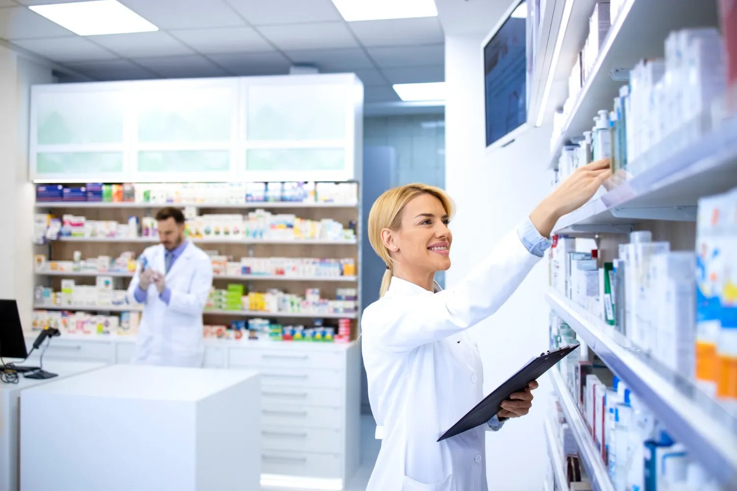 Pharmacist organizing prescriptions as part of a medication synchronization program.