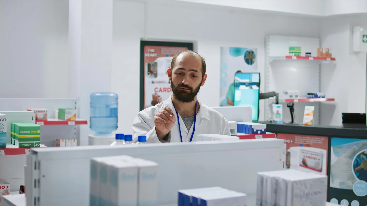 Pharmacist reviewing prescription medications, representing a medsync program for coordinating refill schedules.