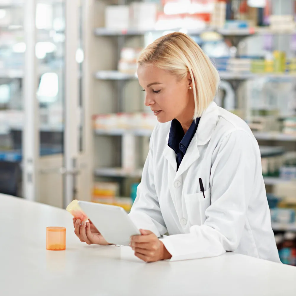Pharmacist organizing prescriptions as part of a medication synchronization program.