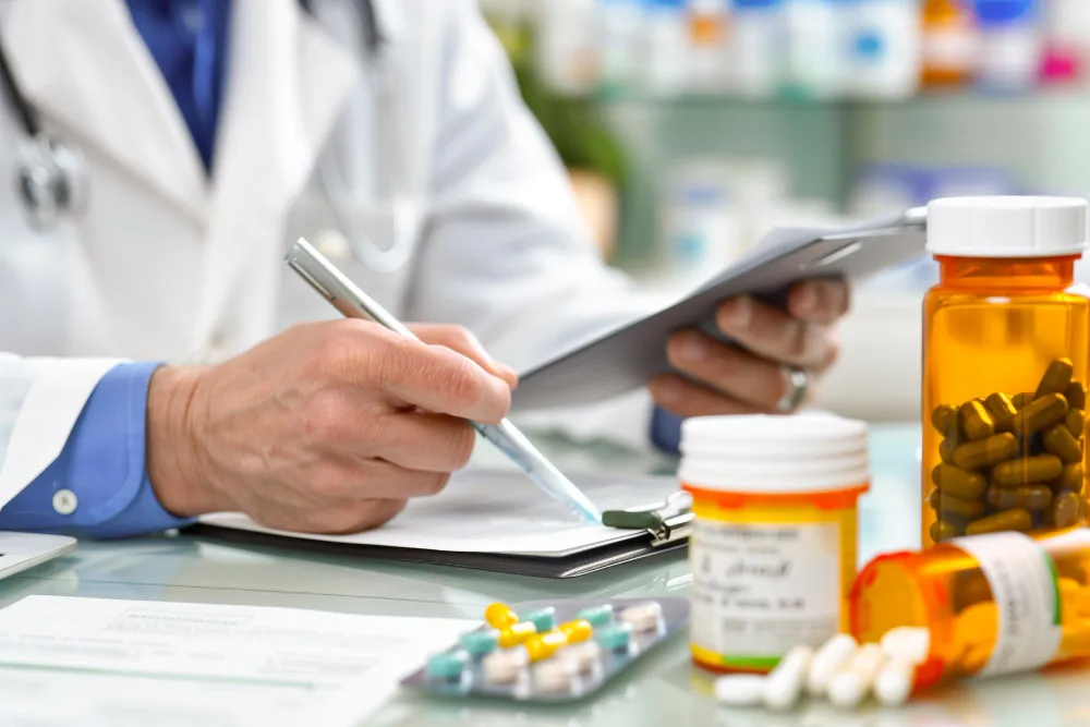Pharmacist preparing prescription medications for a medication synchronization service appointment.