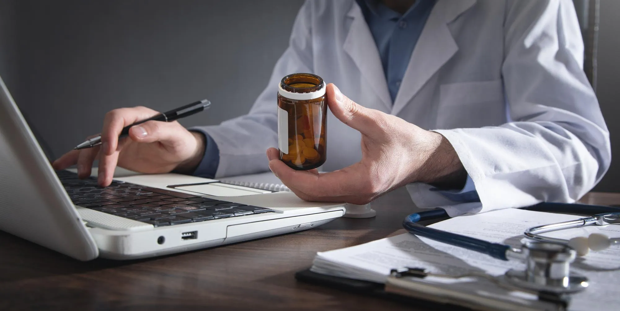 Pharmacist reviewing medication bottles and coordinating prescription synchronization.